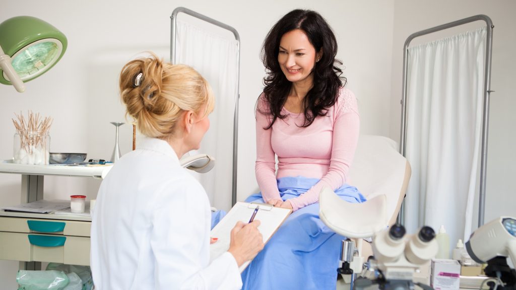 women and doctor at gynaecology appointment.